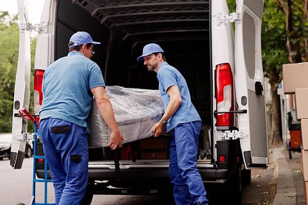 Professional Movers Outside Assisting With Furniture Removal From Client's House.